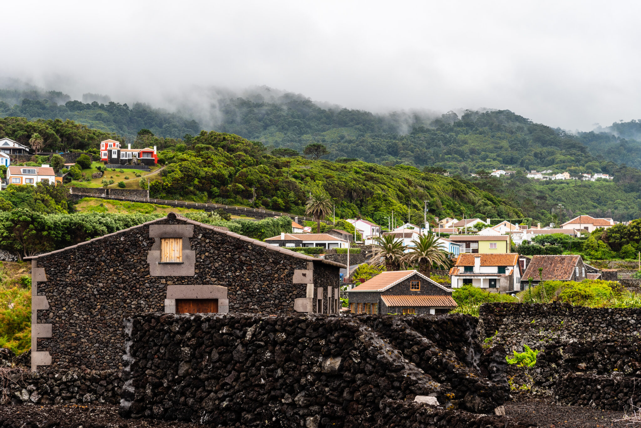 Small village. Traditional rural landscape in Terceira Island a cloudy day of summer. Houses a cloudy day on a green environment